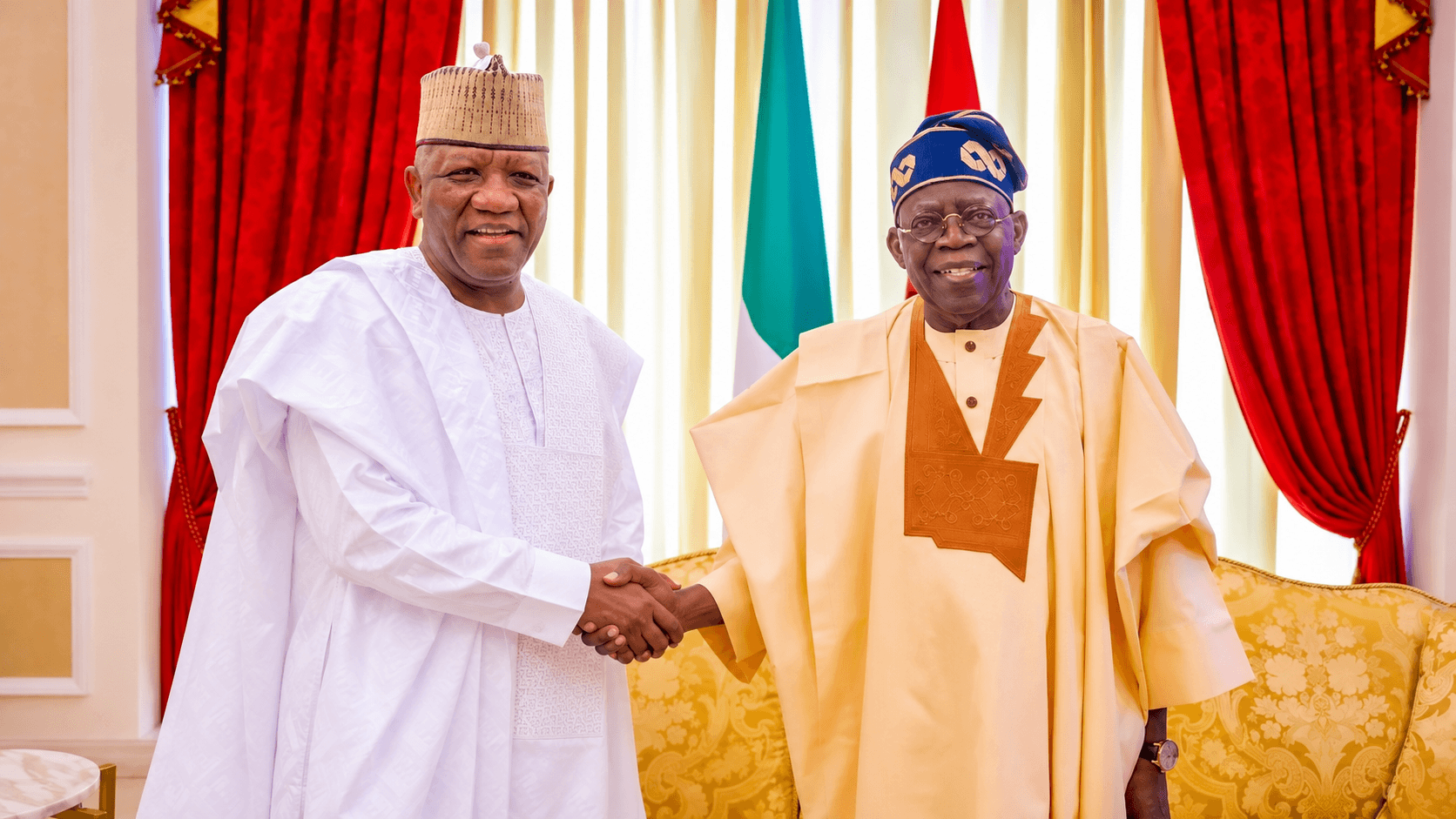 President Bola Ahmed Tinubu and Senator Abdulaziz Yari exchange a handshake.